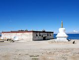 19 Trugo Gompa And Chorten On Lake Manasarovar South Shore With Mount Kailash On the south shore of Lake Manasarovar, the Gelugpa Trugo (Bathing Head) Gompa (4601m) is named for its importance as a place for ritual bathing by Hindus. Hindus immerse themselves totally in the icy water, while Tibetans simply splash water on their heads and drink the water.
